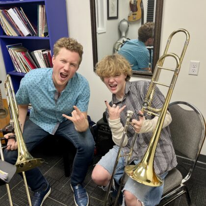 trombone student and teacher, rock face